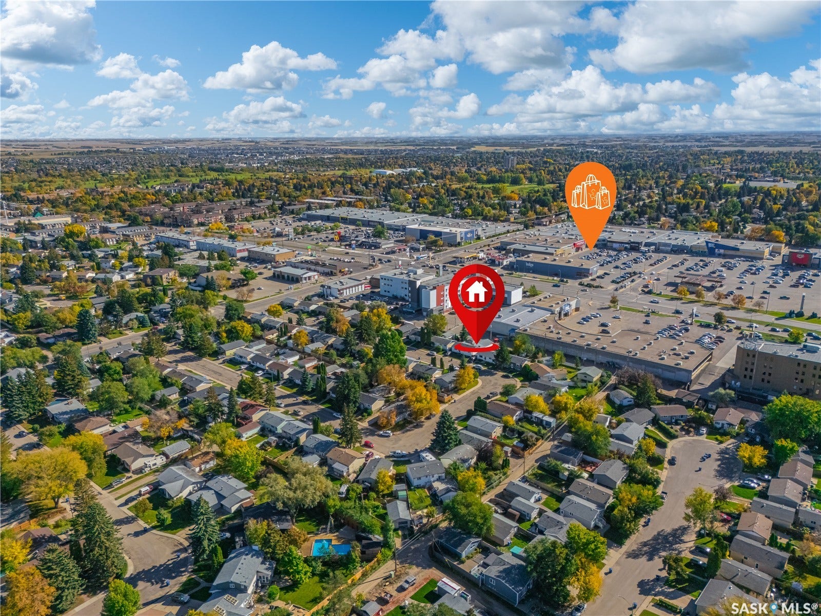 Aerial perspective showcasing a residential area, extensive commercial developments, and mature landscaping