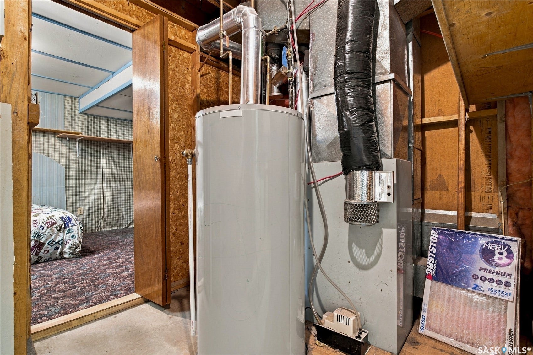 Utility area featuring a water heater and furnace unit