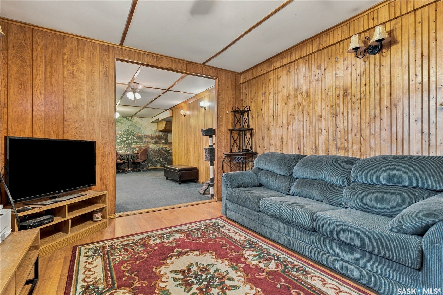 Wood-paneled wall accents, wood-finish flooring, and built-in wall sconces
