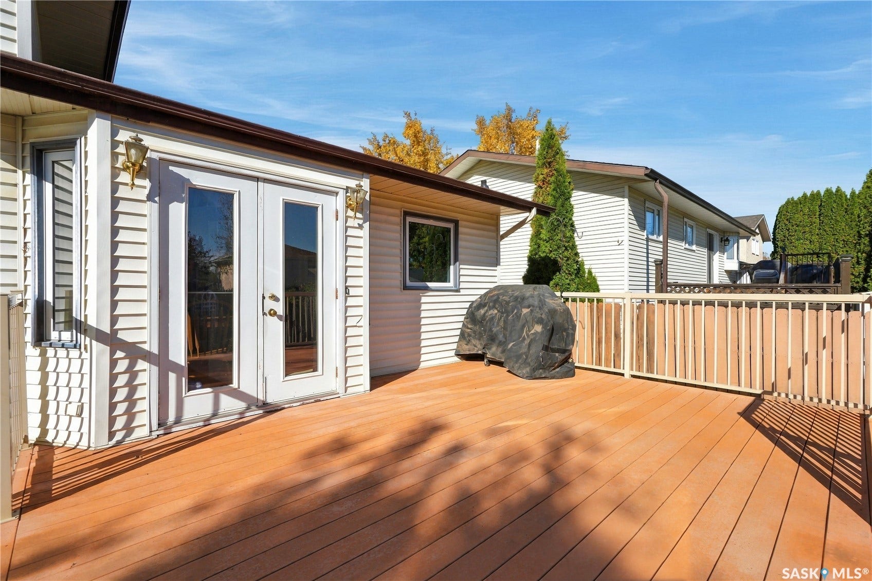 Expansive wood-finish deck with a wood-rail perimeter