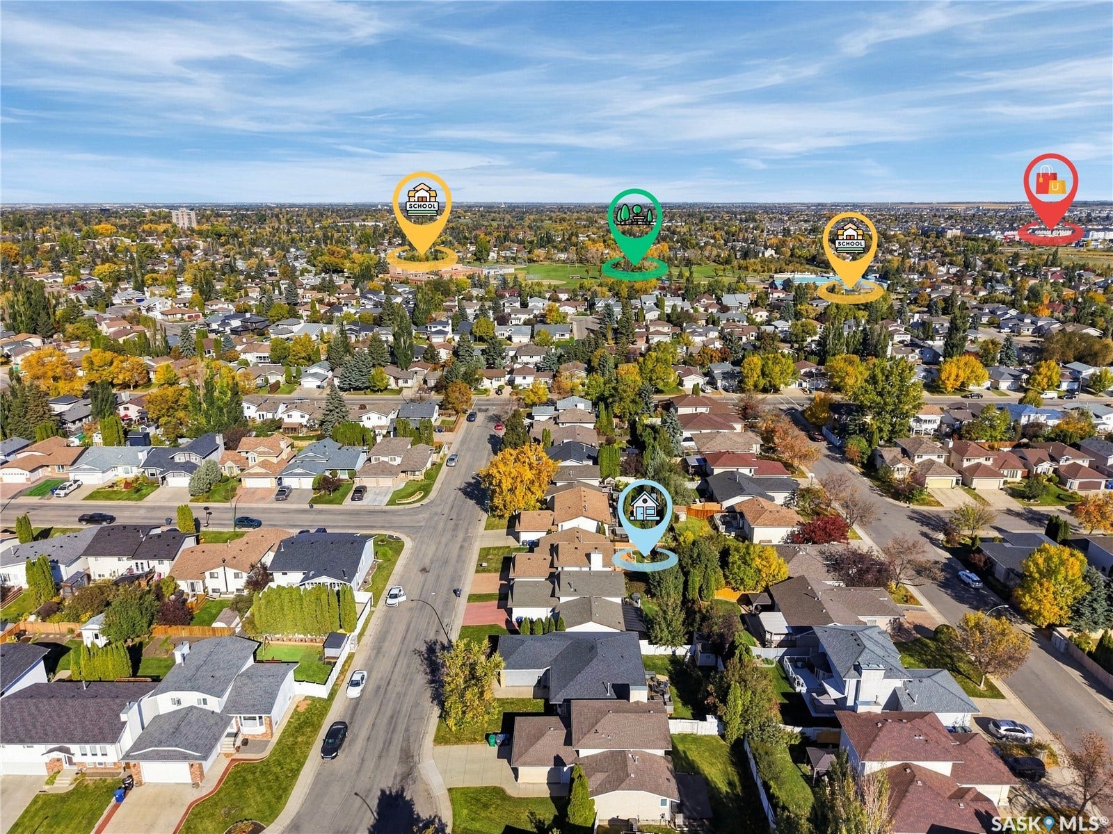 Aerial perspective showcasing a residential area with mature trees and a clear sky