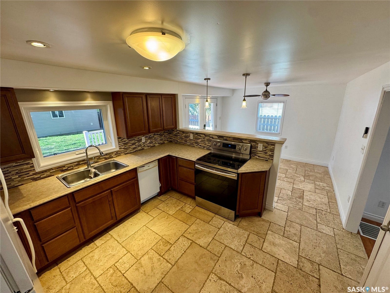 365 Keats Street, Southey SK S0G 4P0 Kitchen featuring wood cabinetry, stainless steel range, and tile flooring
