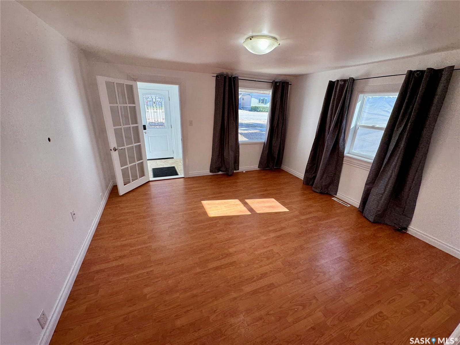 365 Keats Street, Southey SK S0G 4P0 Wood-finish flooring, white walls, and a ceiling-mounted light fixture