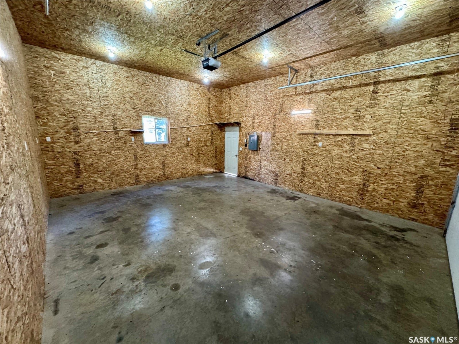 365 Keats Street, Southey SK S0G 4P0 Concrete flooring, finished plywood walls, overhead garage door opener, multiple ceiling-mounted light fixtures, single window
