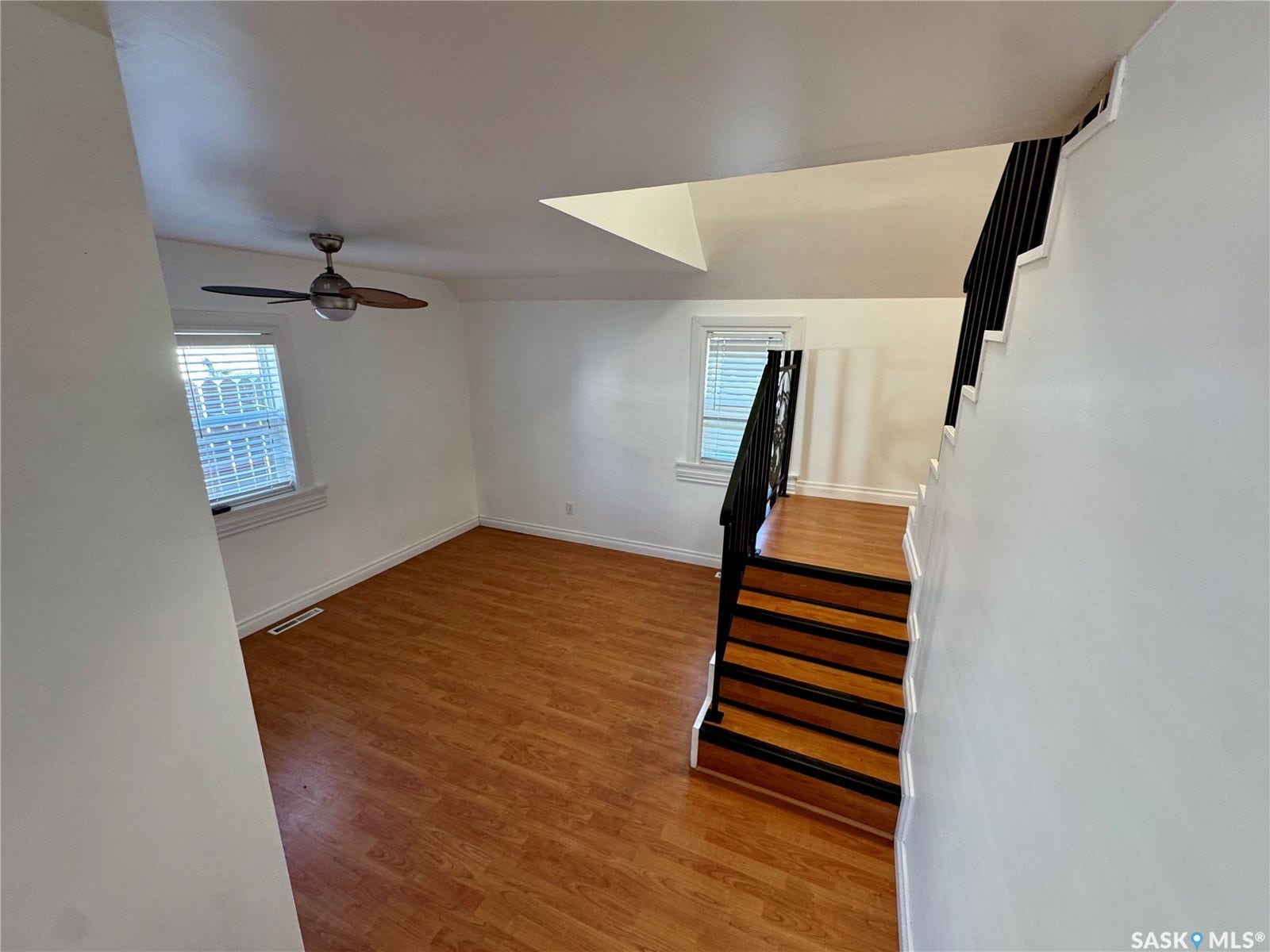 365 Keats Street, Southey SK S0G 4P0 Wood-finish flooring, white walls, and a ceiling fan with integrated lighting
