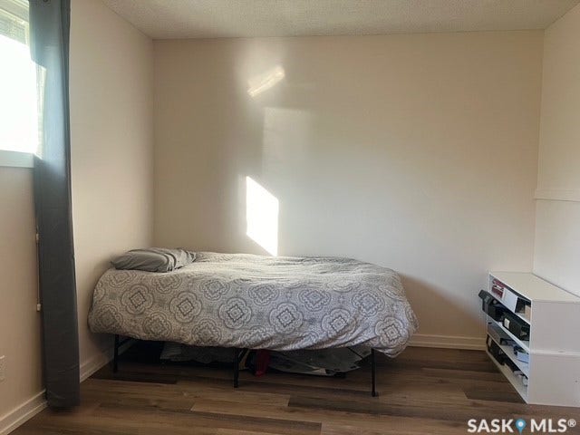 Wood-finish flooring with white baseboards