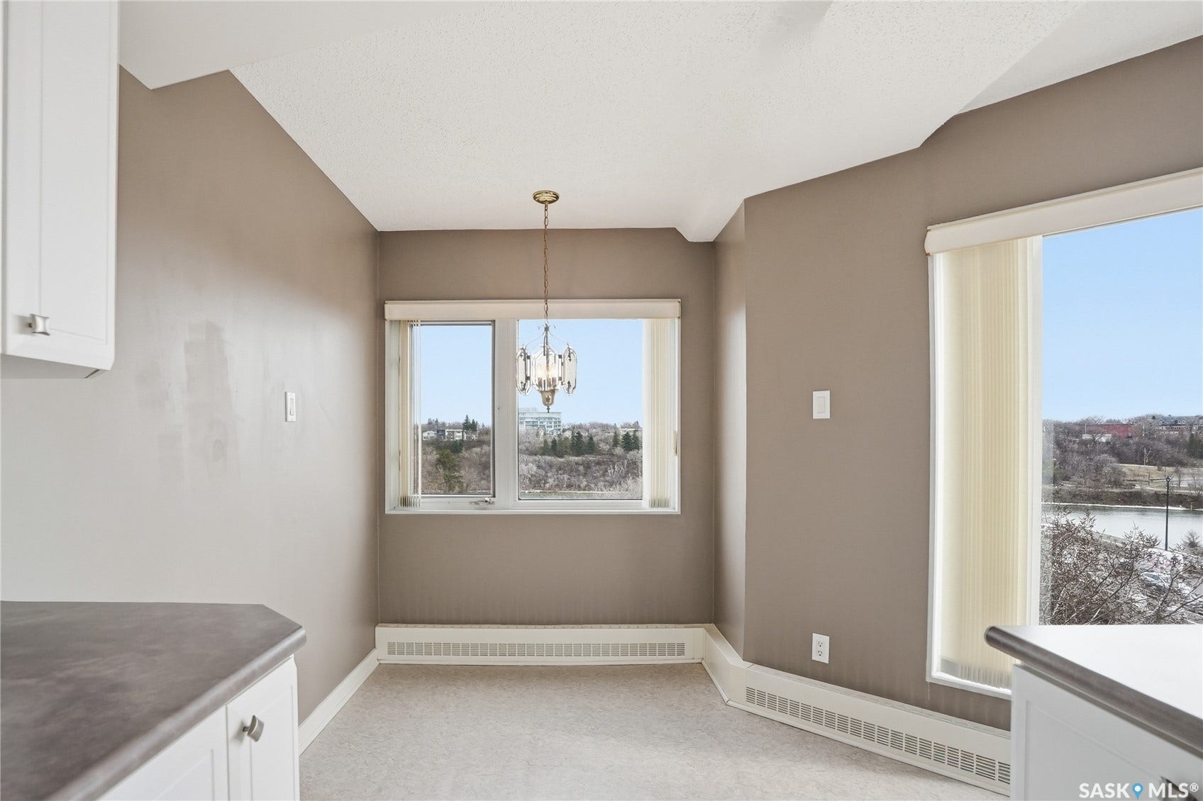Recessed lighting, warm neutral wall tones, and white cabinetry