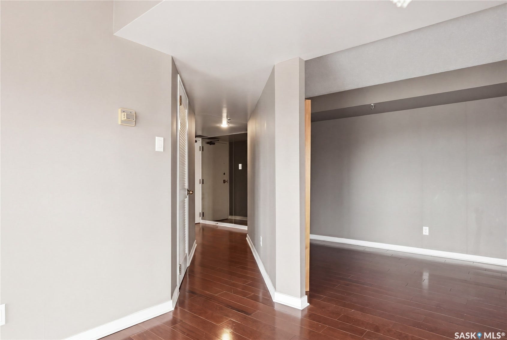 Hardwood flooring, painted interior walls, recessed lighting, and white trim