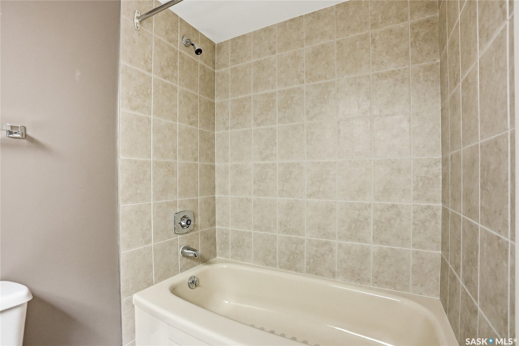 Bathtub with tiled surround and chrome fixtures