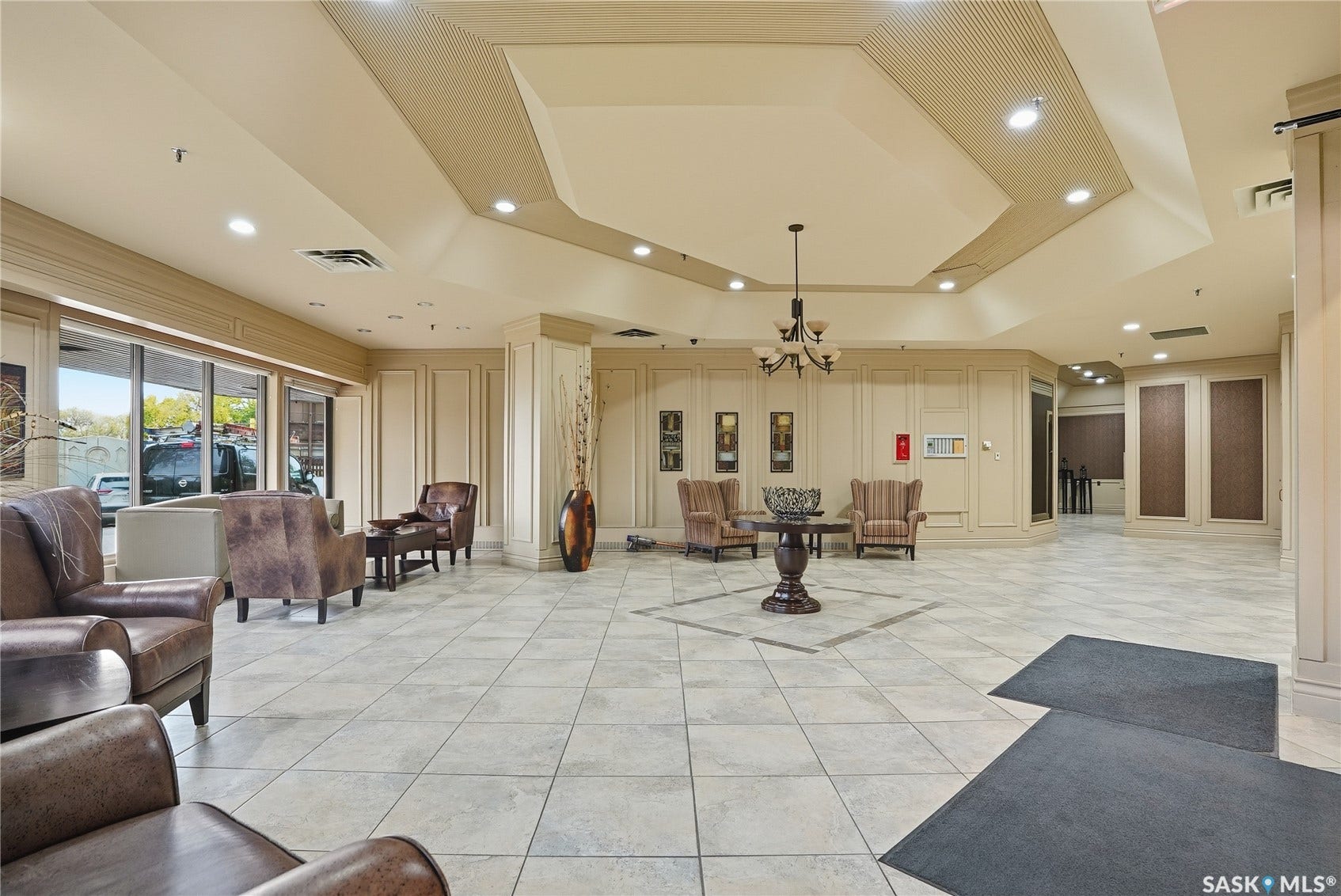 Spacious foyer featuring tiled flooring, a decorative chandelier, recessed lighting, and expansive windows