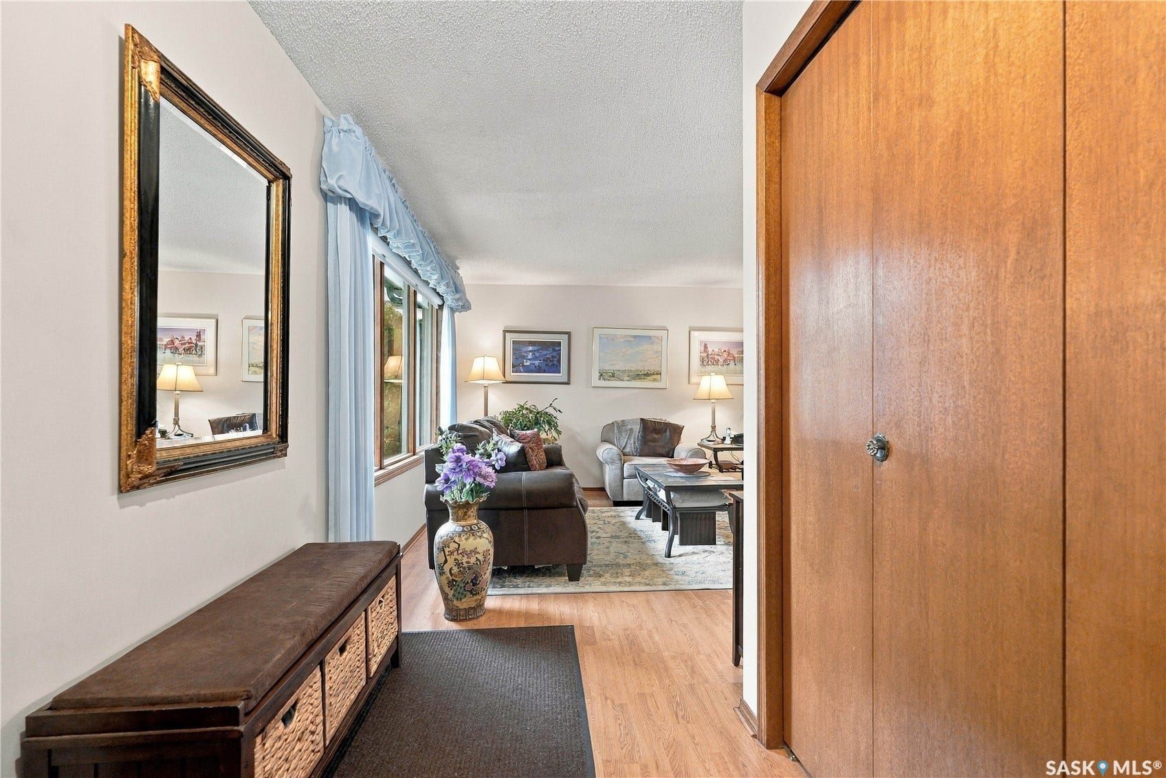 Light wood-finish flooring extending into the main living space