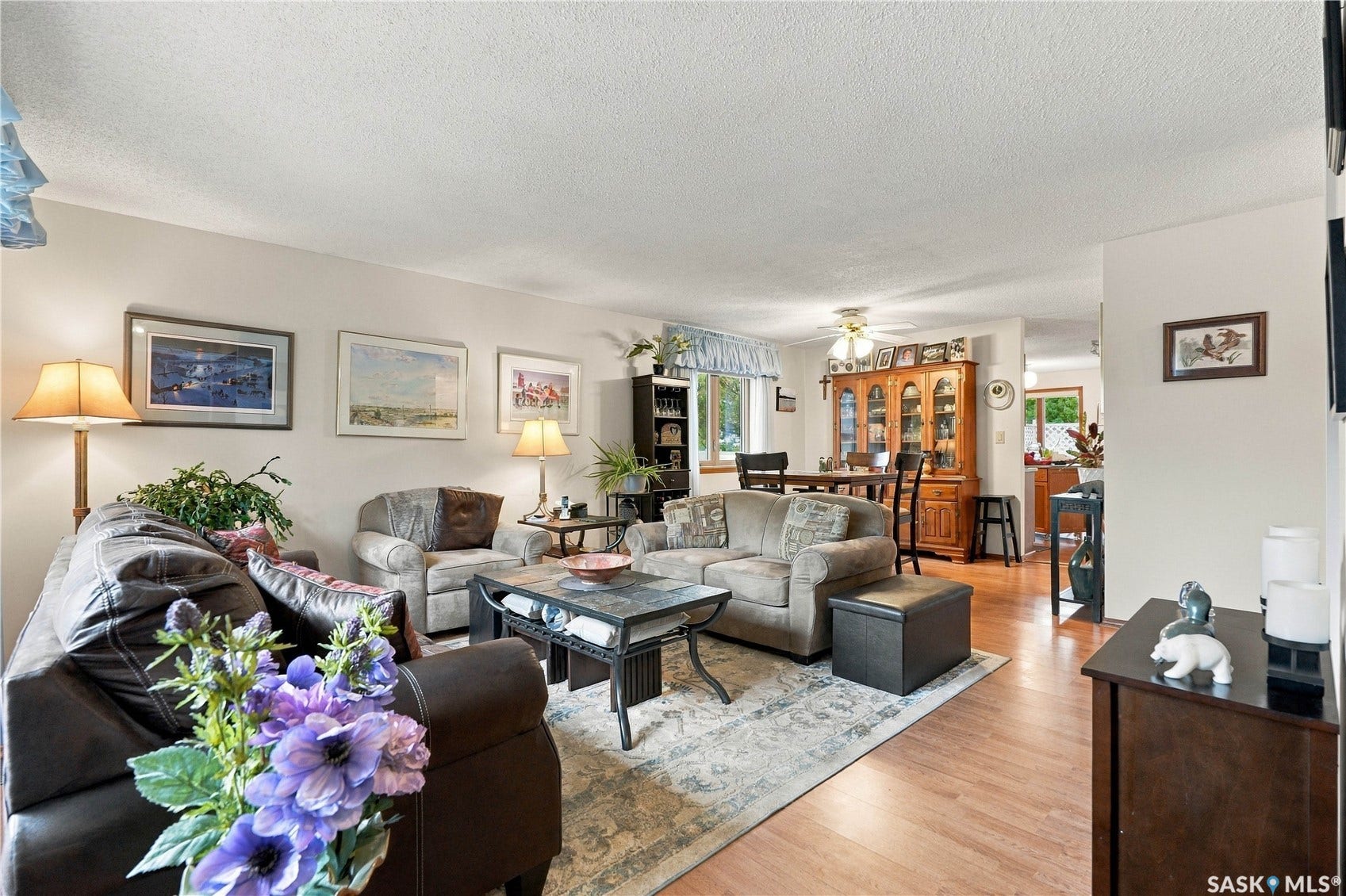 Light wood-finish flooring throughout, neutral wall paint, and a textured ceiling