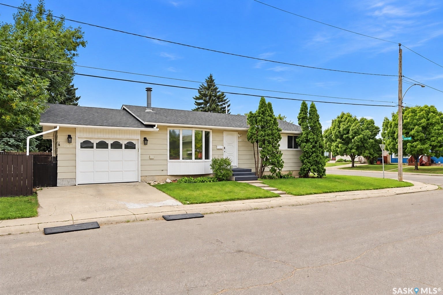 Single-story residence featuring a two-car garage, front yard landscaping, and a corner lot location