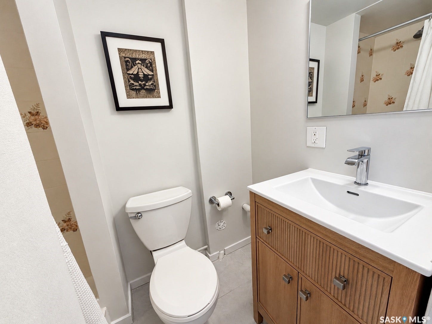 Modern vanity with a sleek white countertop and integrated sink, chrome faucet, and a large wall-mounted mirror