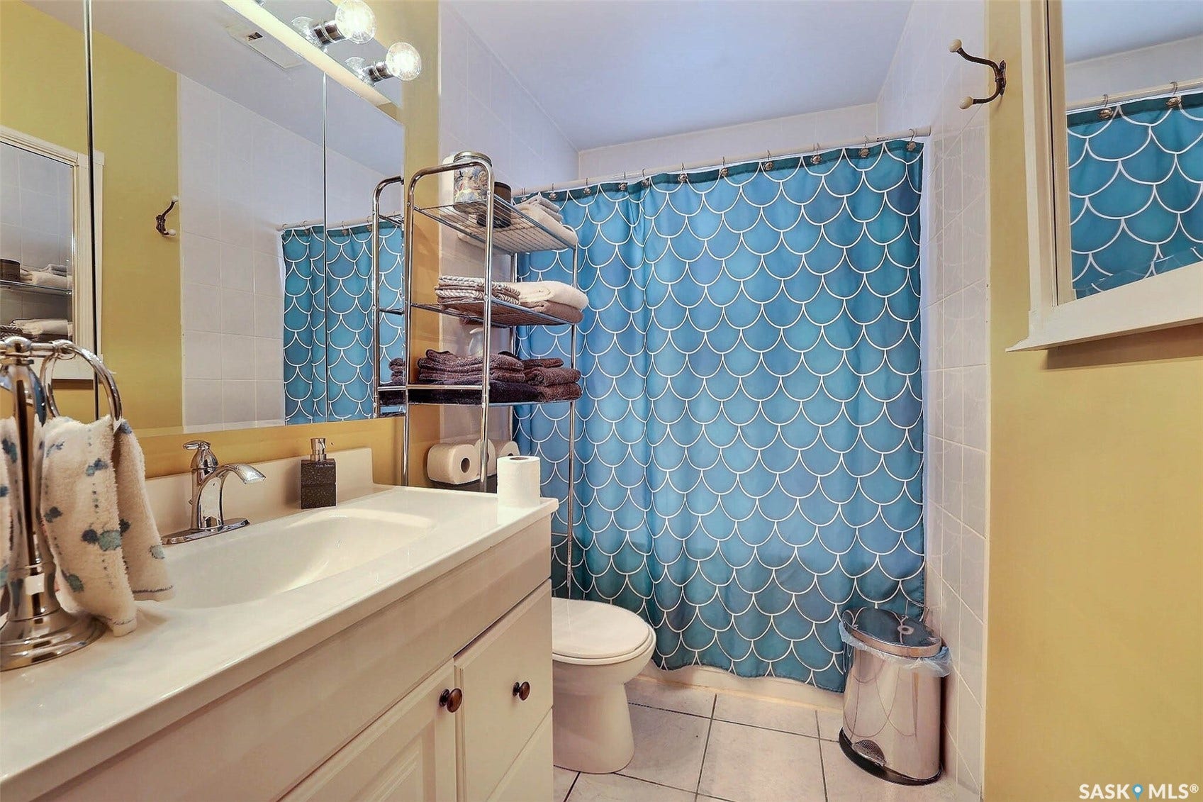 Vanity with integrated sink, chrome faucet, and storage cabinetry