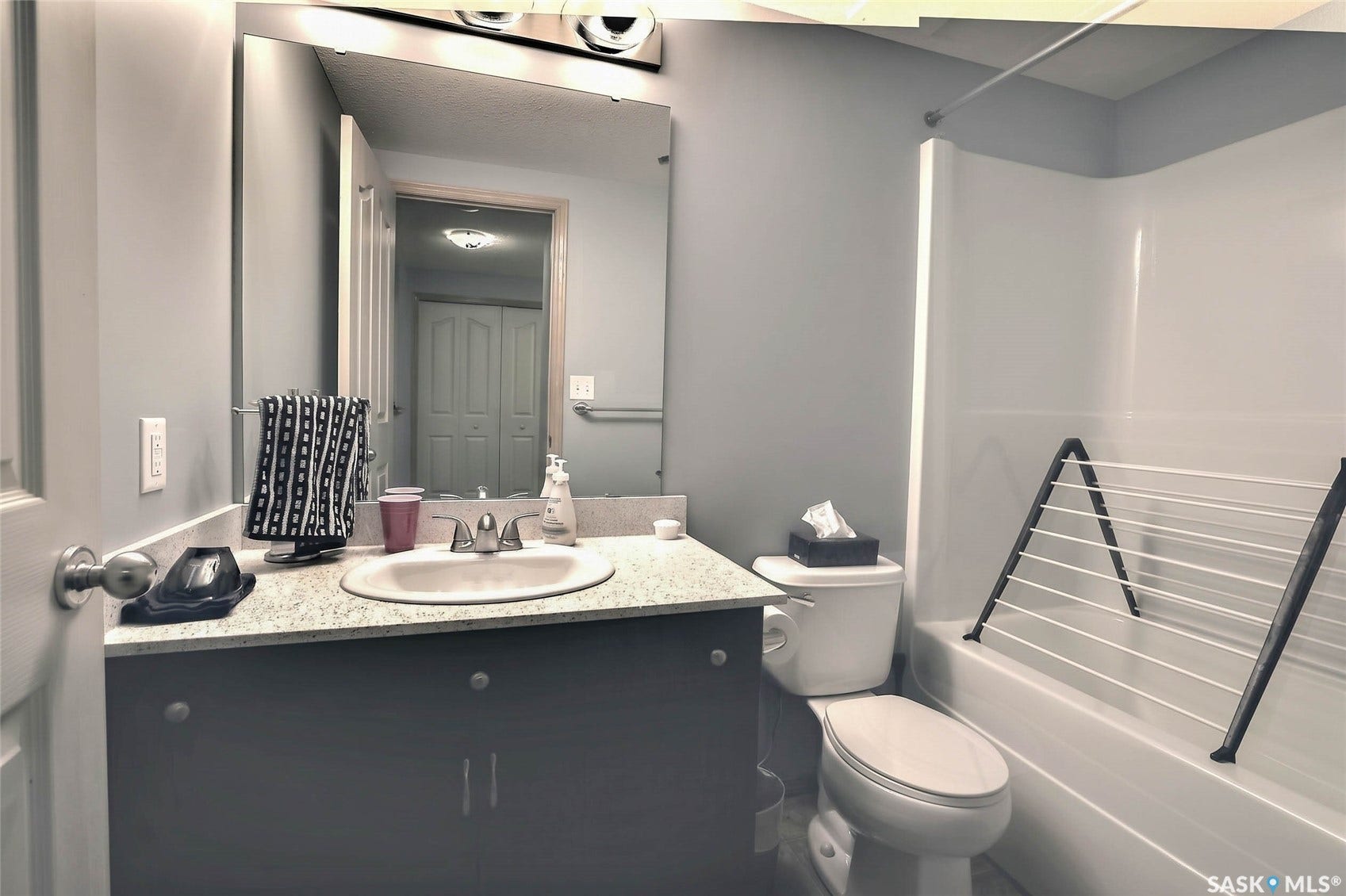 Vanity with a built-in sink, granite-style countertop, and dark wood-finish cabinetry