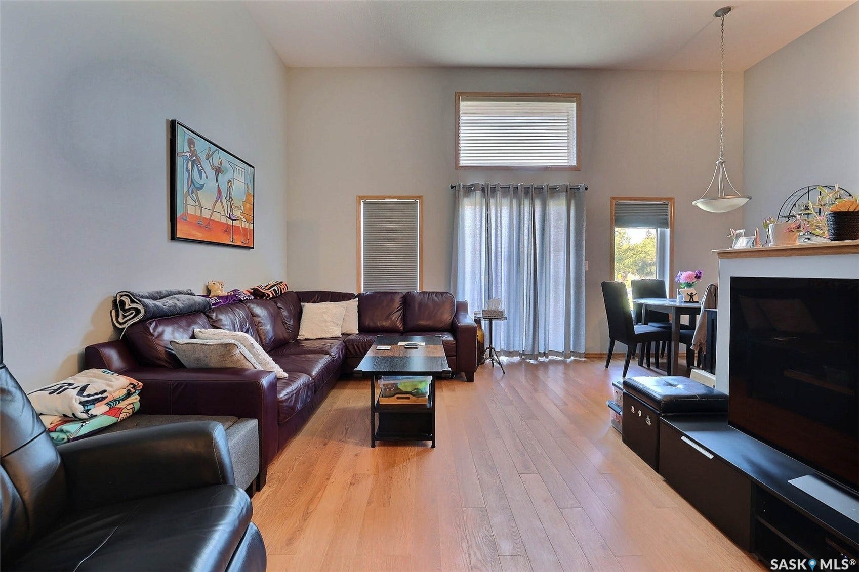 Vaulted ceilings, wood-finish flooring, and multiple windows