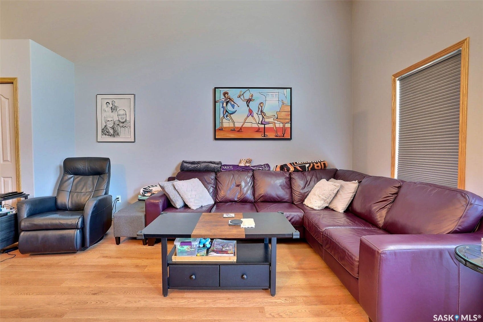 Wood-finish flooring with light wall tones and a vaulted ceiling