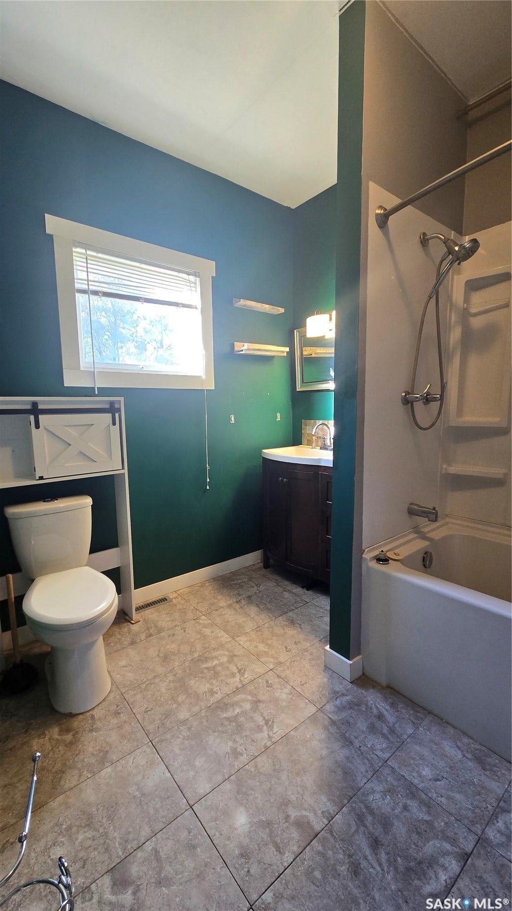 Tiled flooring complementing the toilet and sink vanity