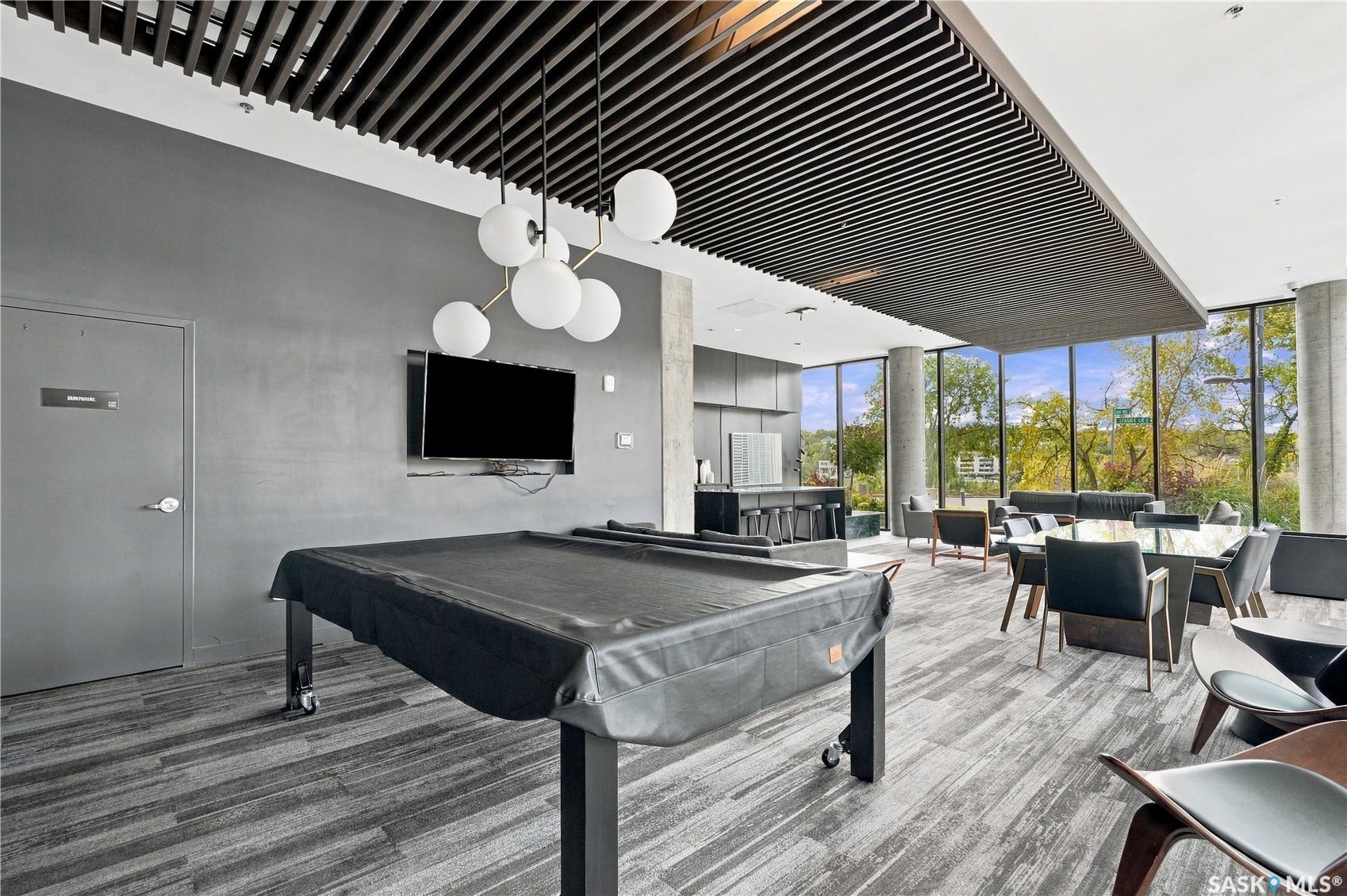 Full height windows, recessed lighting, wood-finish flooring, built-in bar, and suspended ceiling panels
