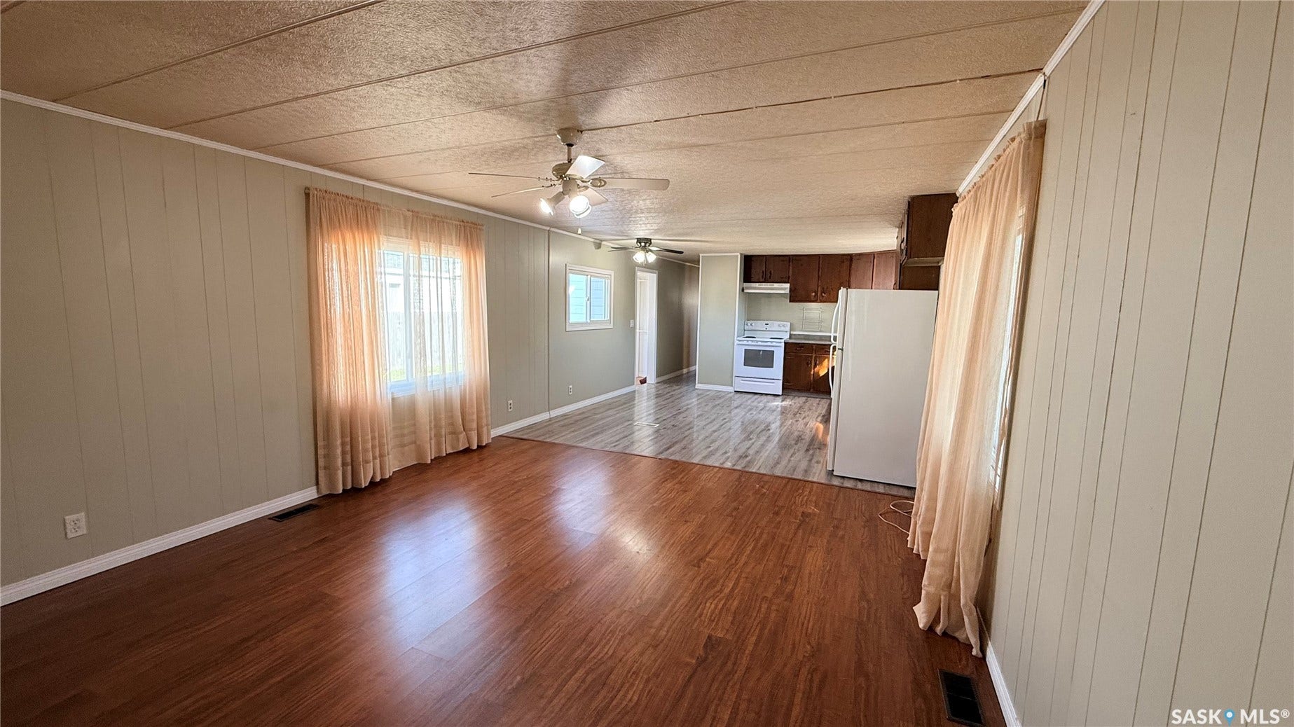 Expansive open-concept layout with wood-finish flooring