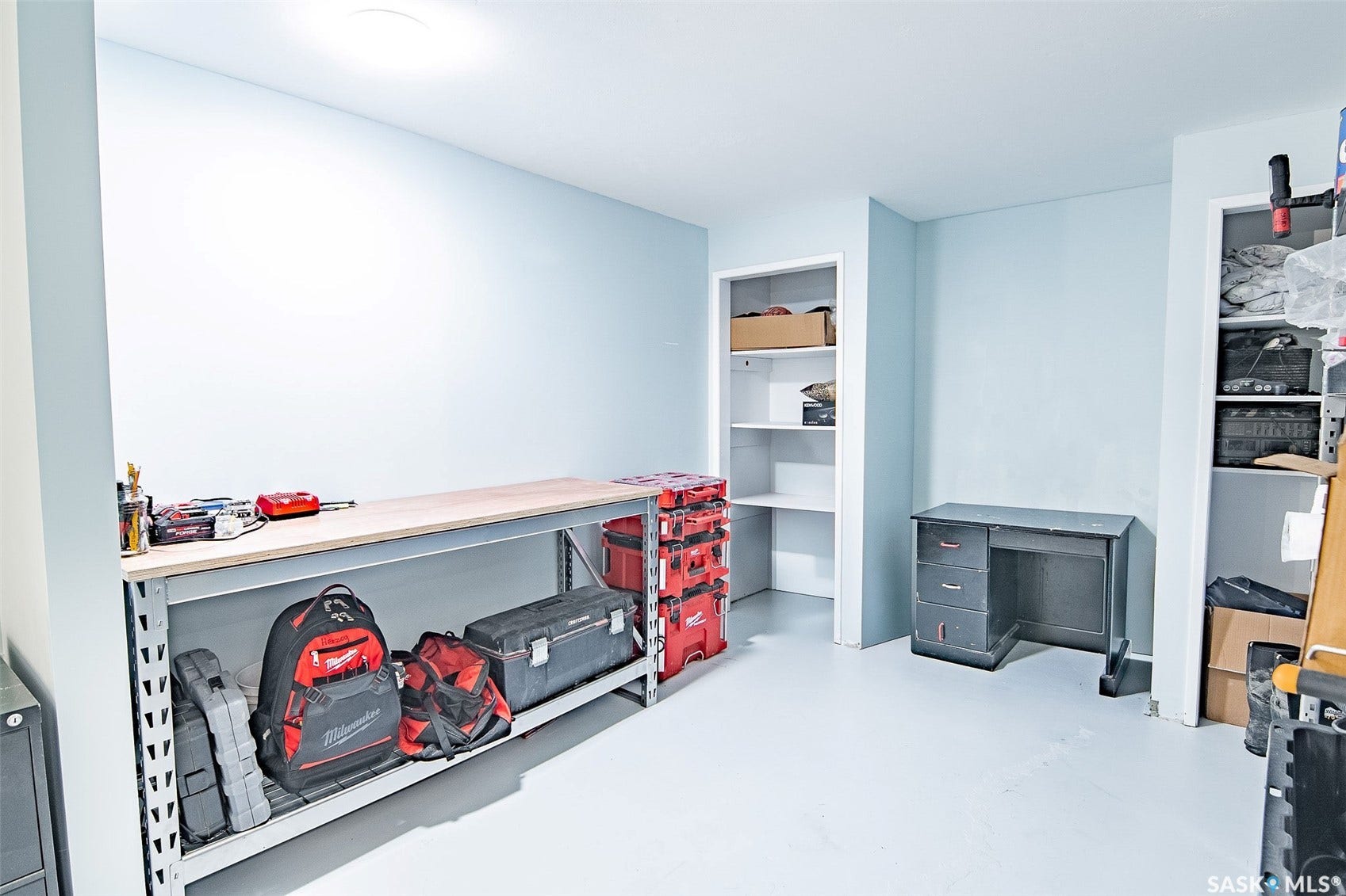 Built-in shelving units, light-toned walls, and recessed lighting