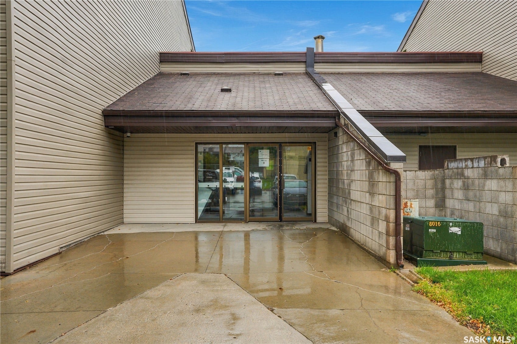 Sliding glass door entry, concrete patio, and horizontal siding exterior
