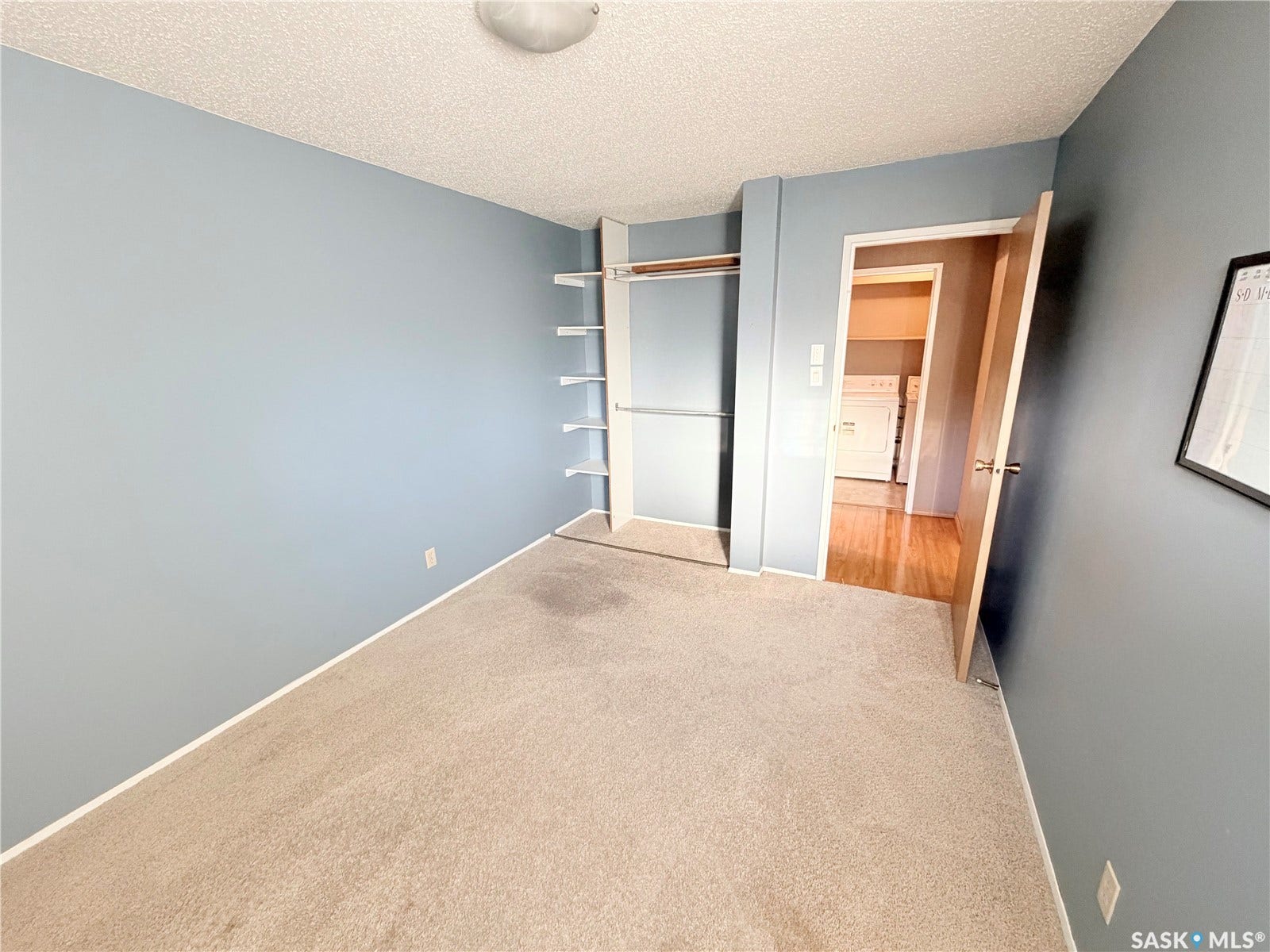Recessed closet with built-in shelving and hanging rod