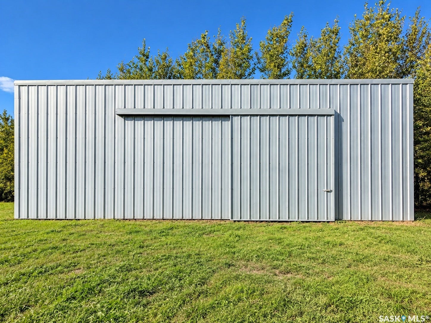 Corrugated metal exterior with a sliding door and an integrated access door