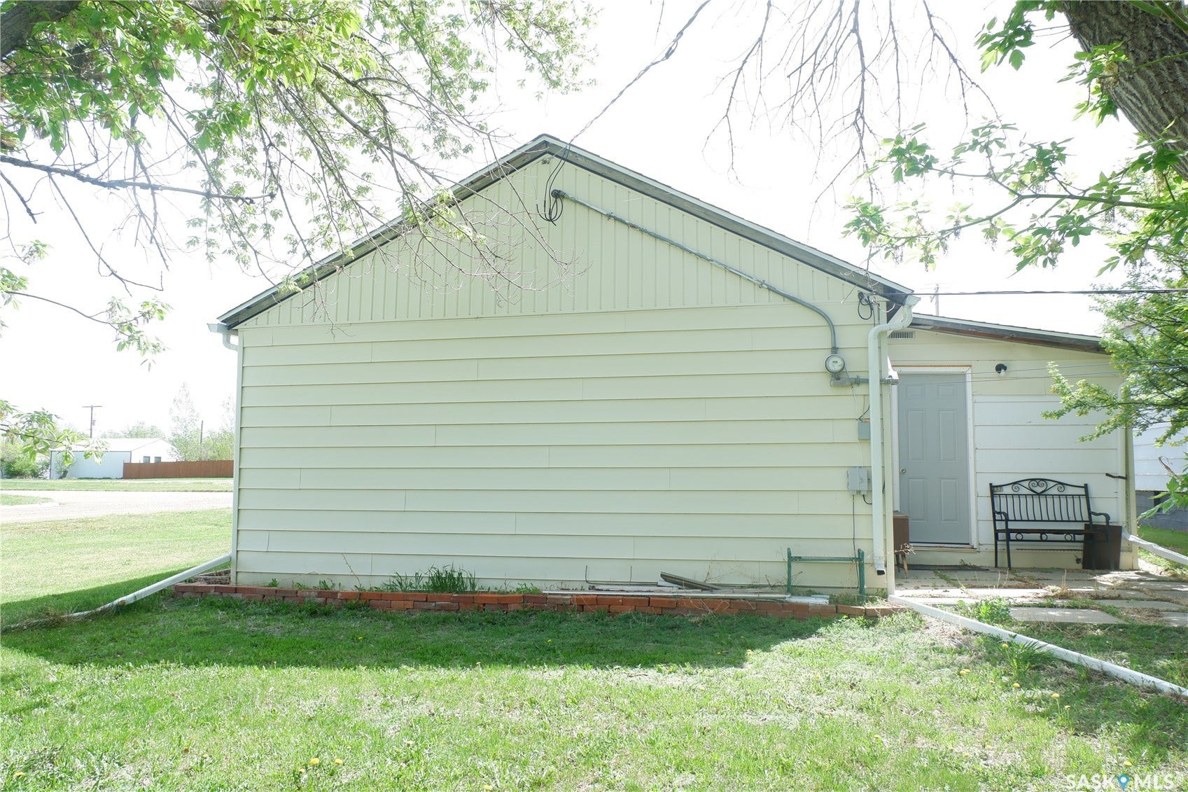 View of side of property featuring a yard