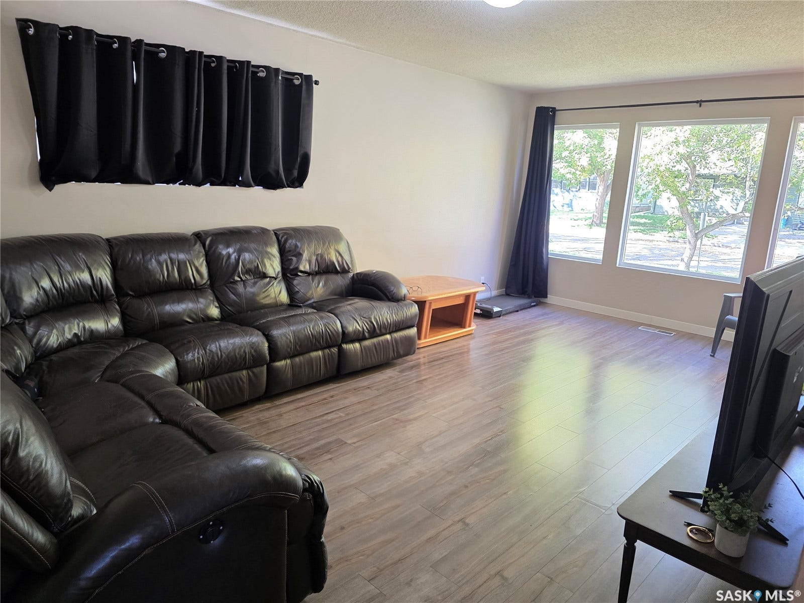 Neutral wall paint, wood-finish flooring, and recessed lighting