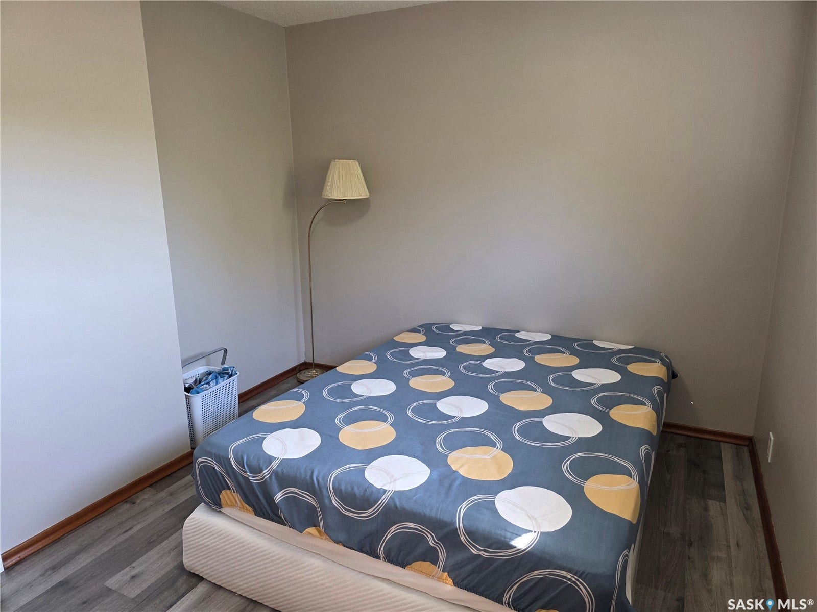 Light gray wall finish with wood-finish flooring