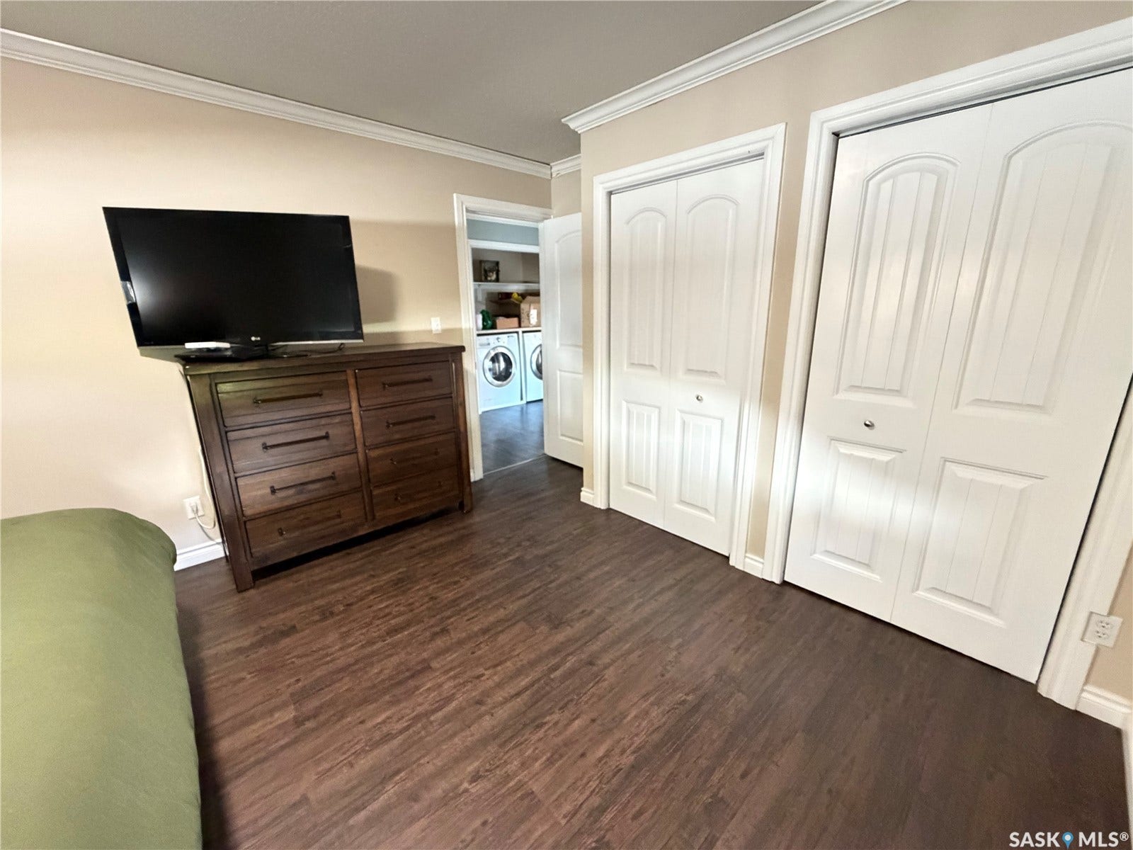 Dark wood-finish flooring complements light-toned walls and white trim
