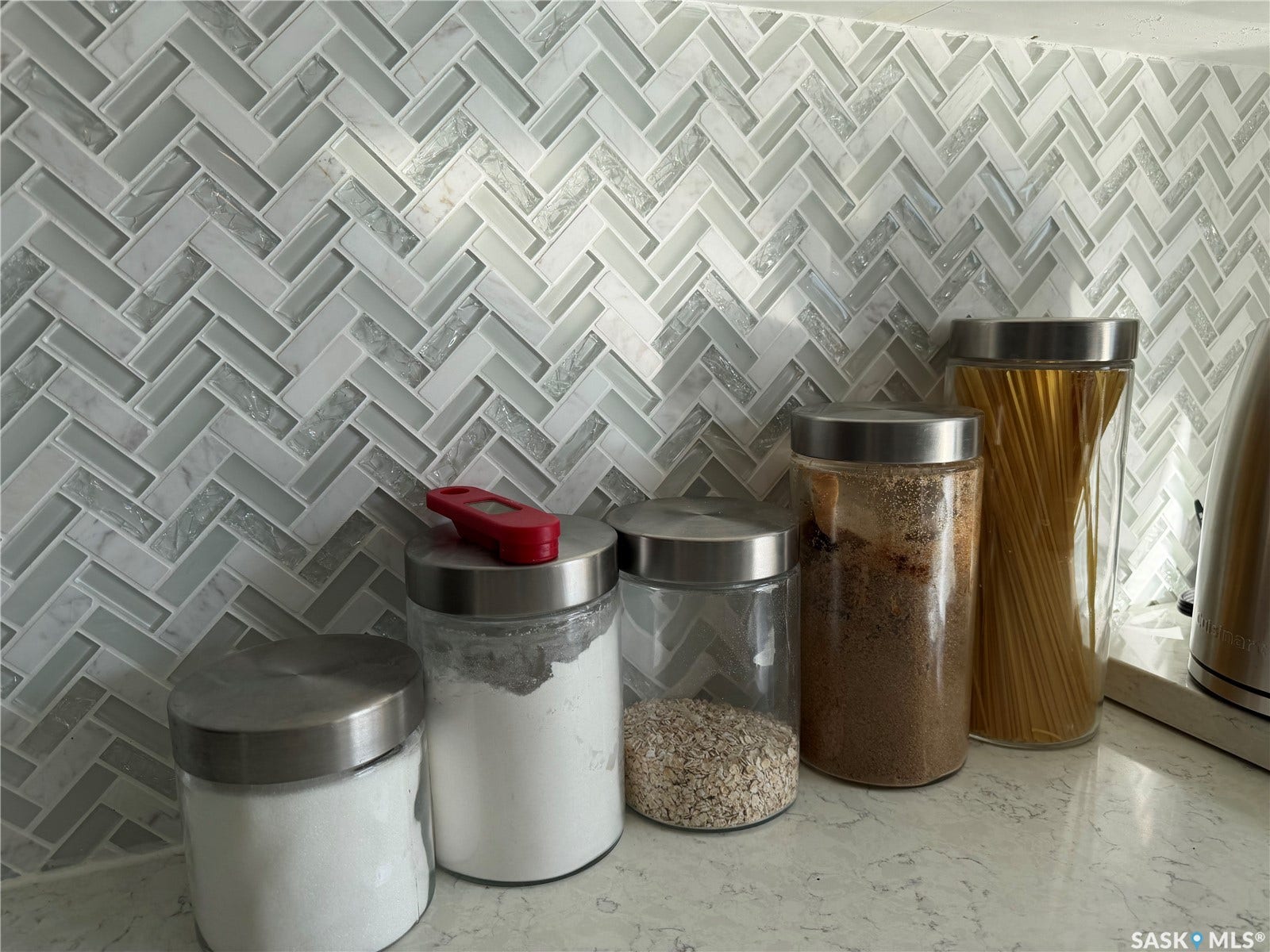 Herringbone pattern backsplash featuring varied tones
