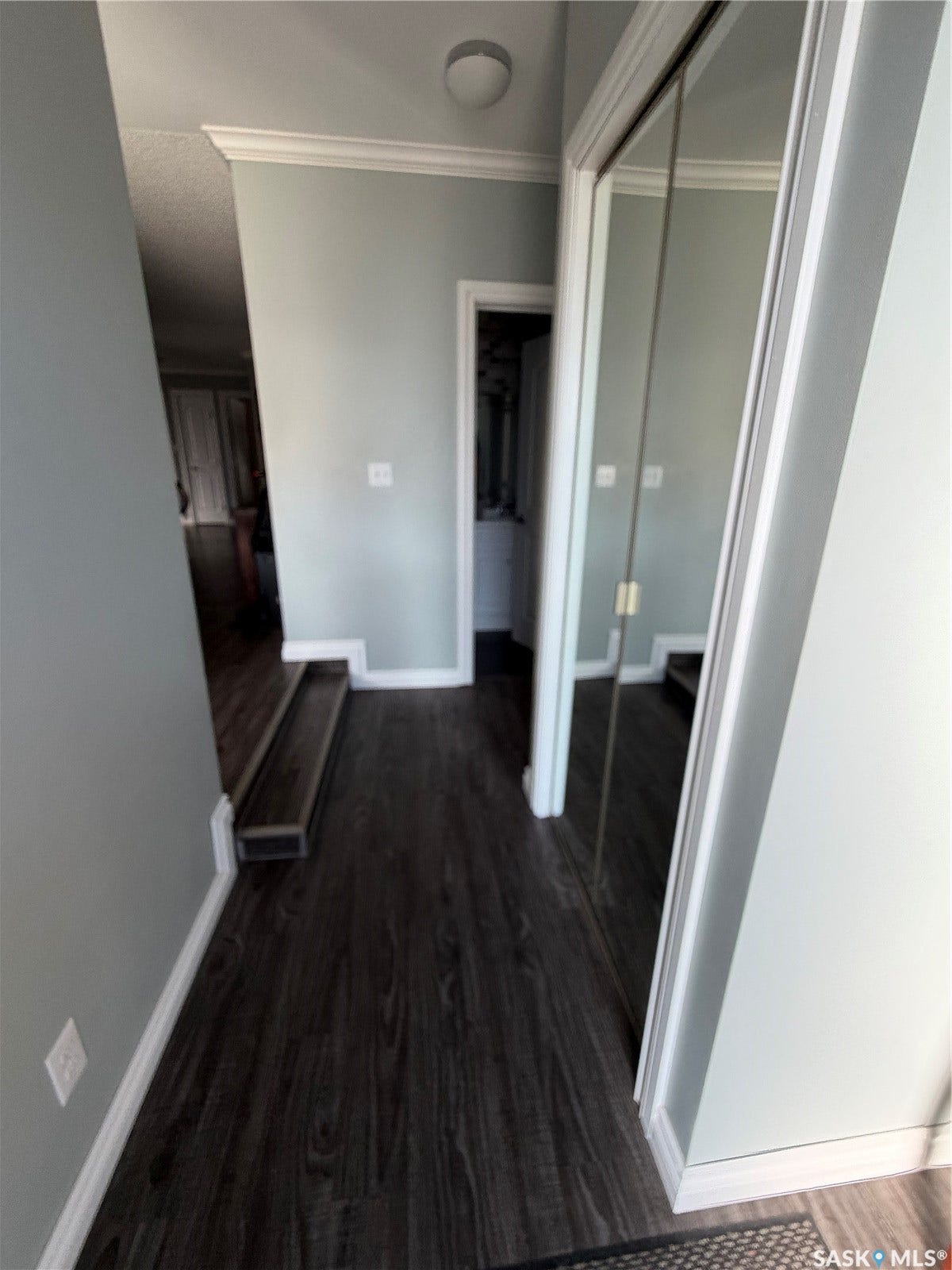 Wood-finish flooring throughout, complemented by crown molding and white trim