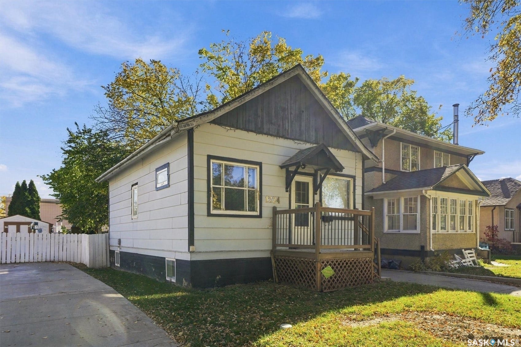 Single-story residence featuring light-colored siding and dark trim