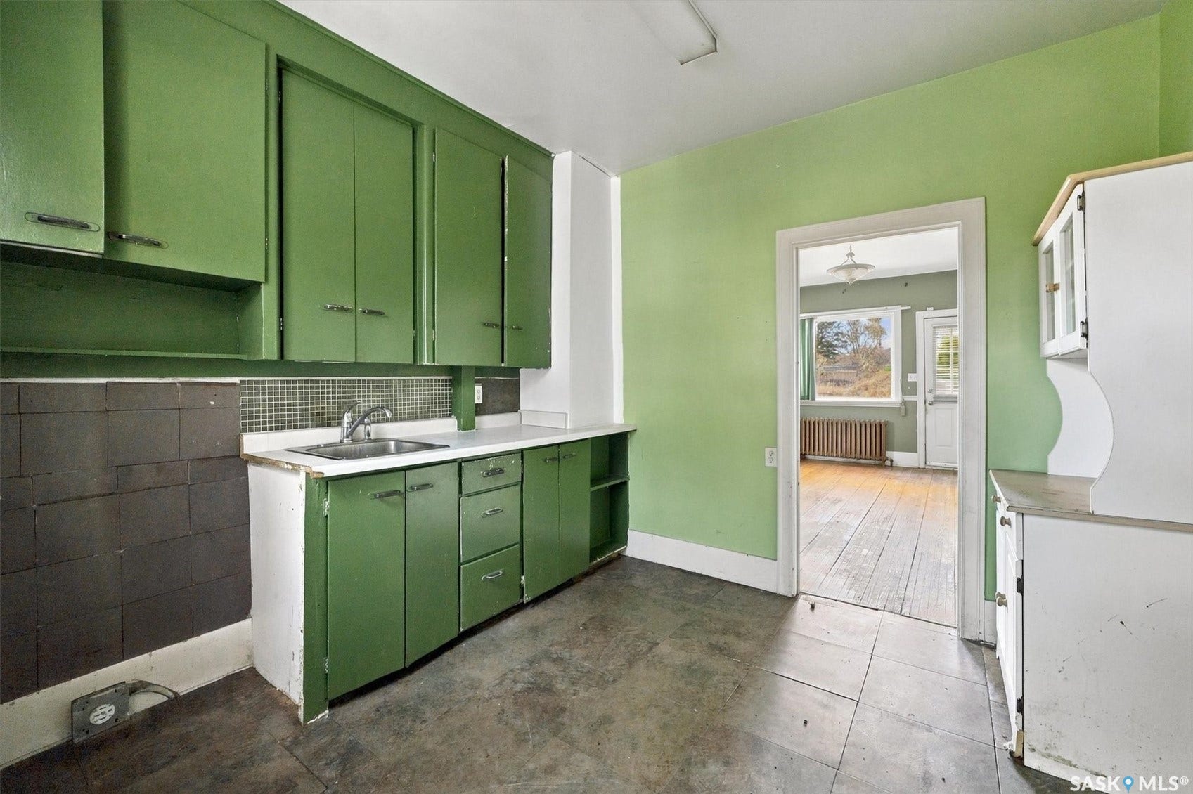 Kitchen featuring floor-to-ceiling cabinetry, a built-in sink, and solid surface countertops