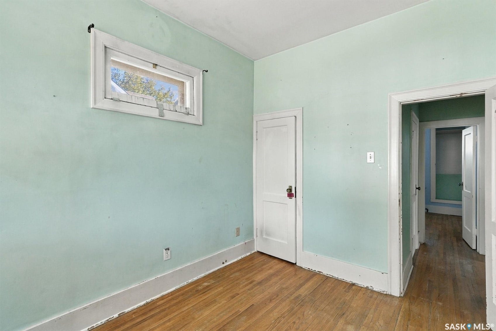 Wood-finish flooring with light green walls