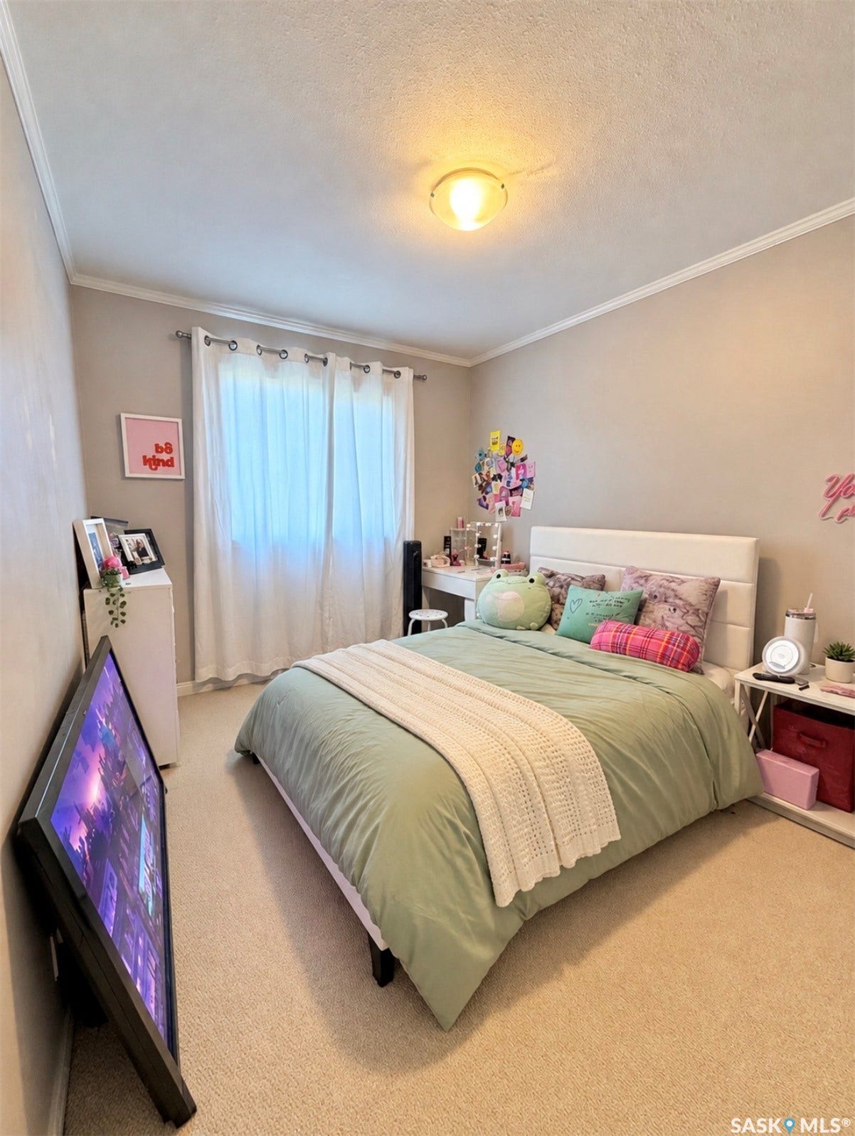 Wall-to-wall carpeting with crown molding, a window with curtains, and a flush mount ceiling light