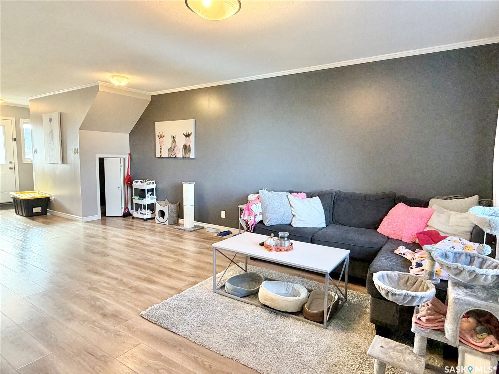 Wood-finish flooring throughout, featuring a broad room with neutral wall tones