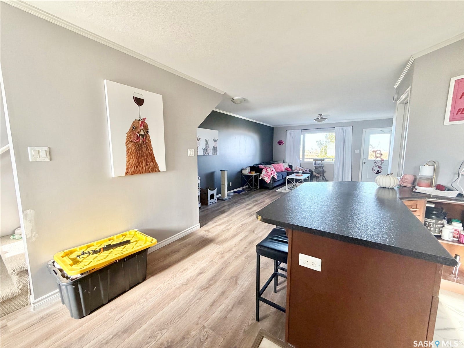 Wood-finish flooring throughout, with a built-in breakfast bar featuring a dark countertop