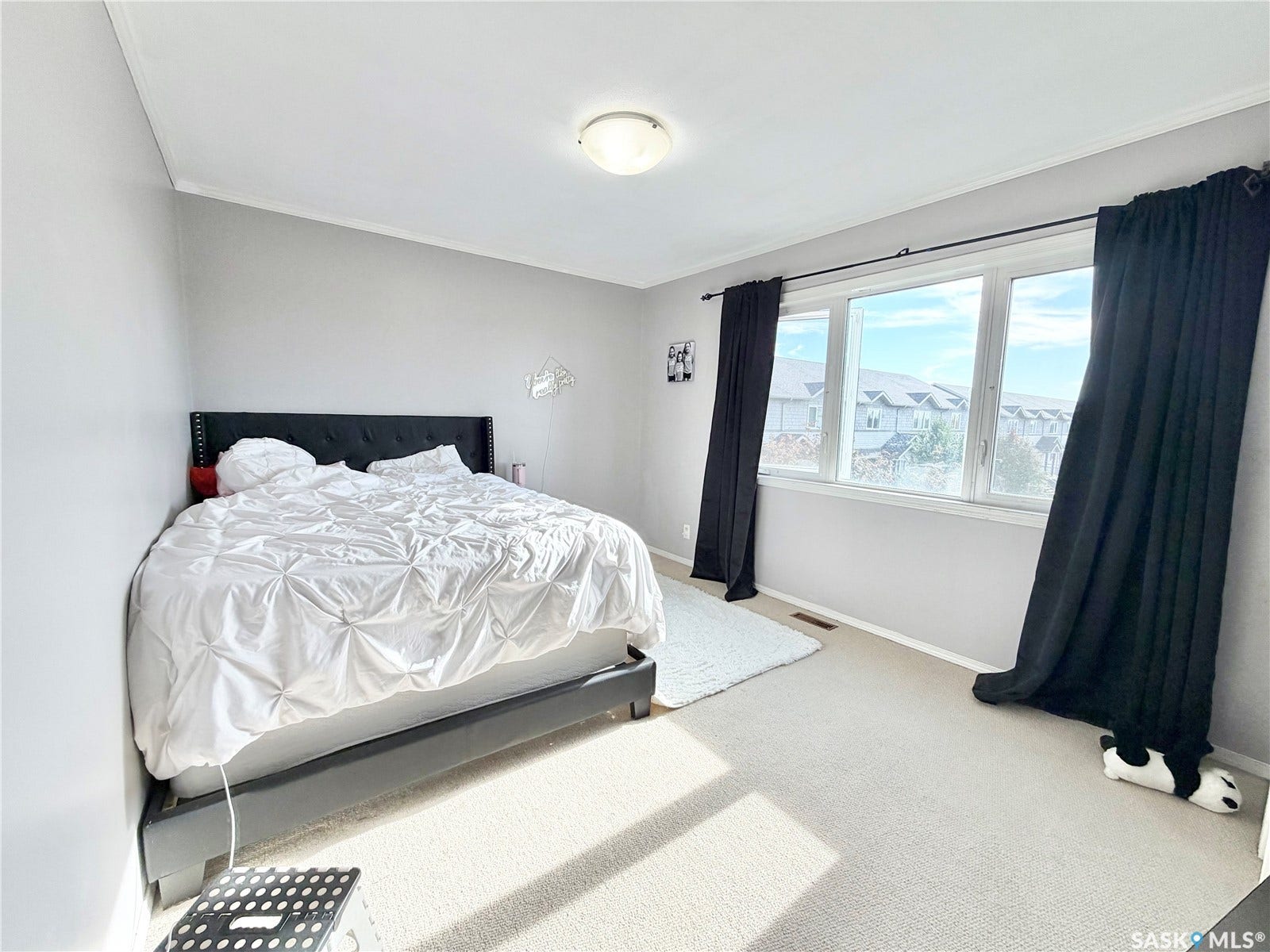 Wall-to-wall carpeting with natural light from a multi-pane window