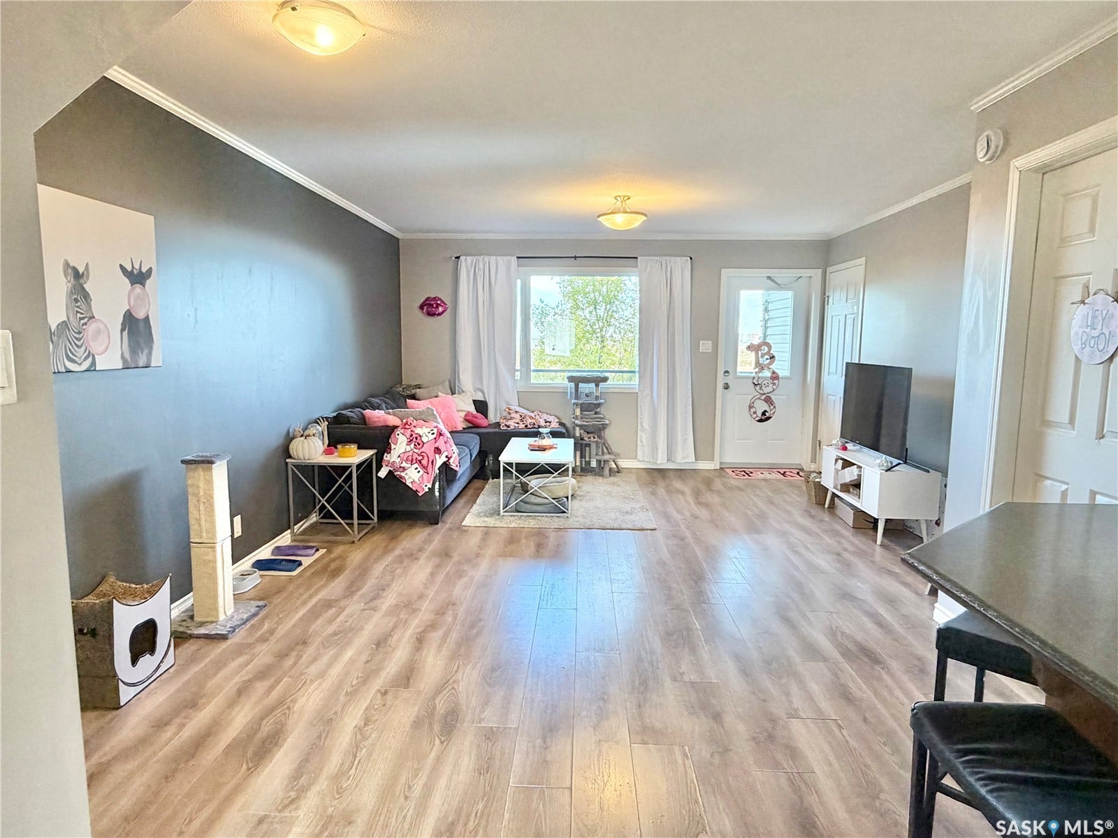 Wood-finish flooring throughout, complemented by crown molding