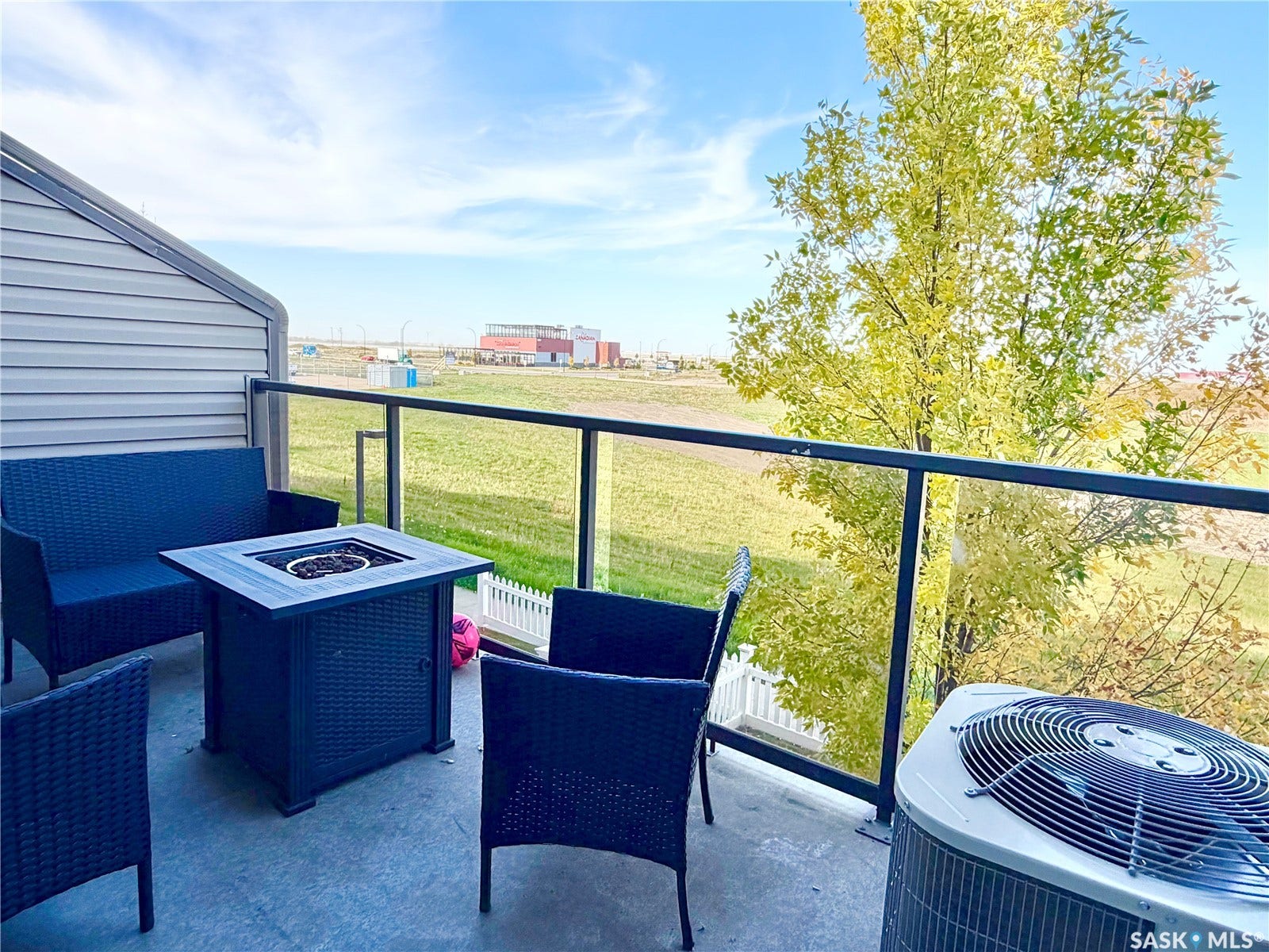 Patio featuring a glass railing, concrete flooring, and horizontal siding