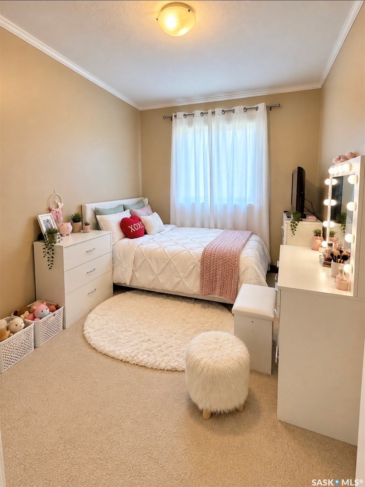 Neutral tone wall paint, flush mount ceiling light, window with sheer curtains, crown molding, and carpet flooring