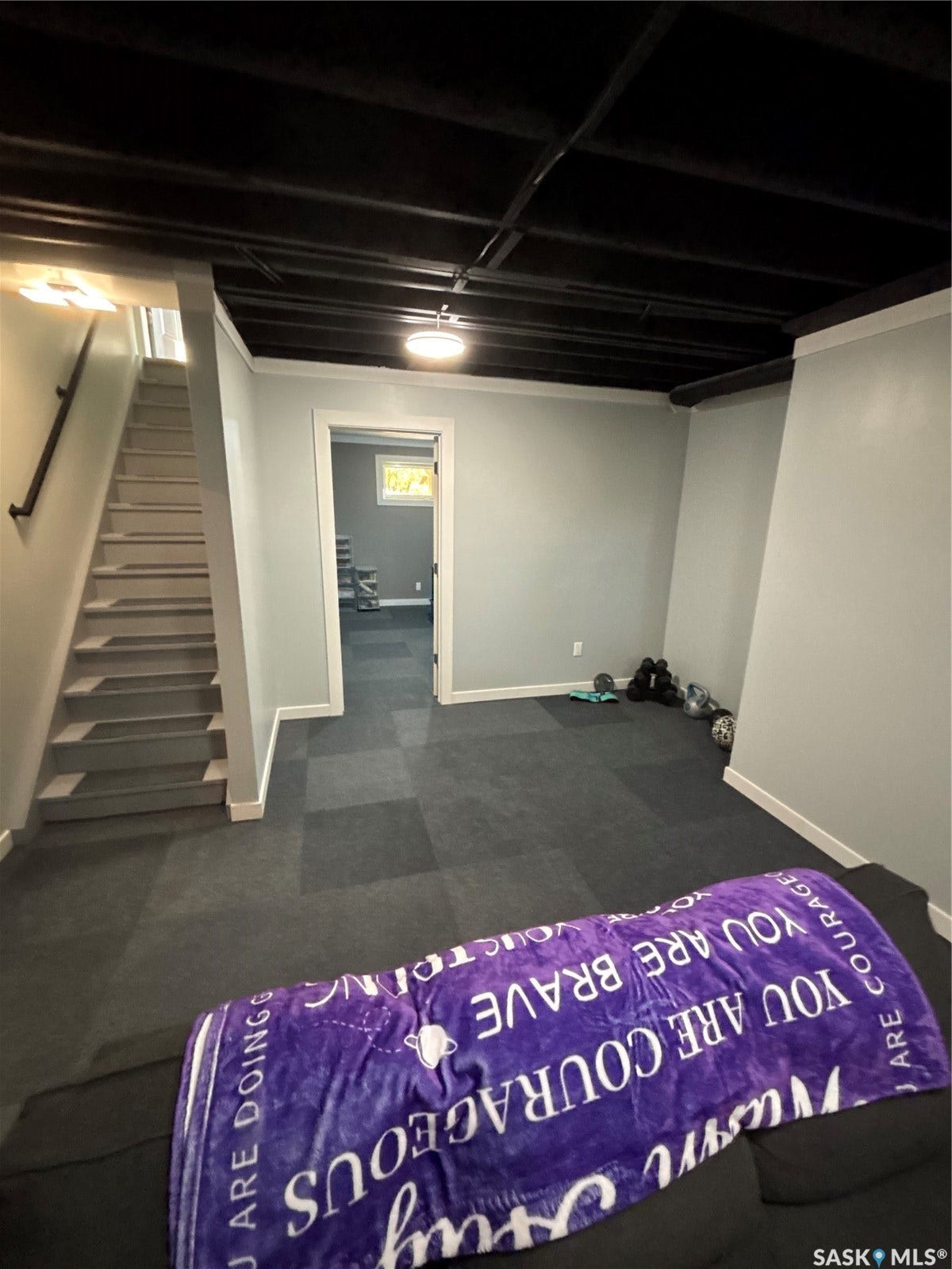 Recessed ceiling with exposed black-painted joists