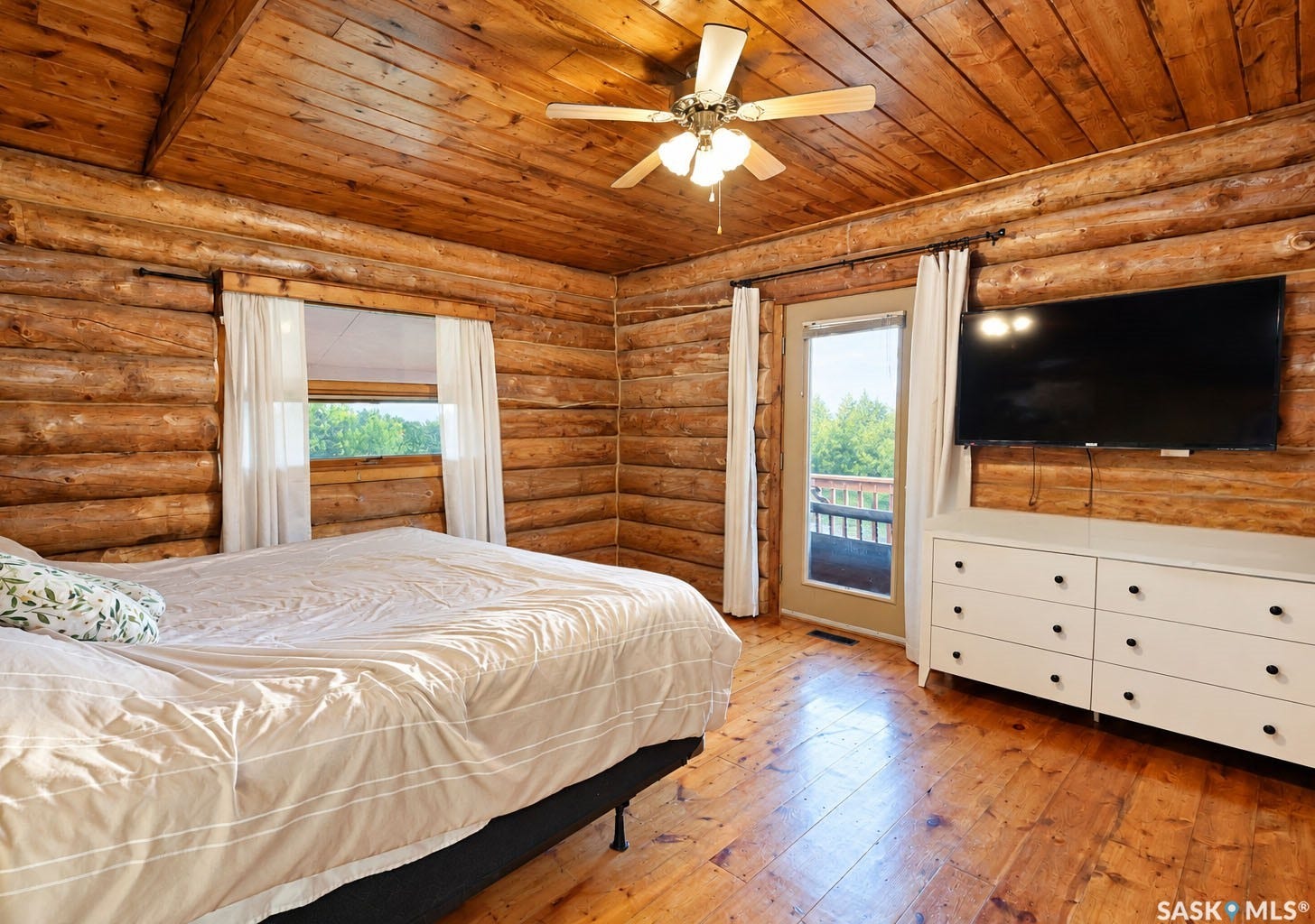 Wood-paneled walls and ceiling with polished wood flooring