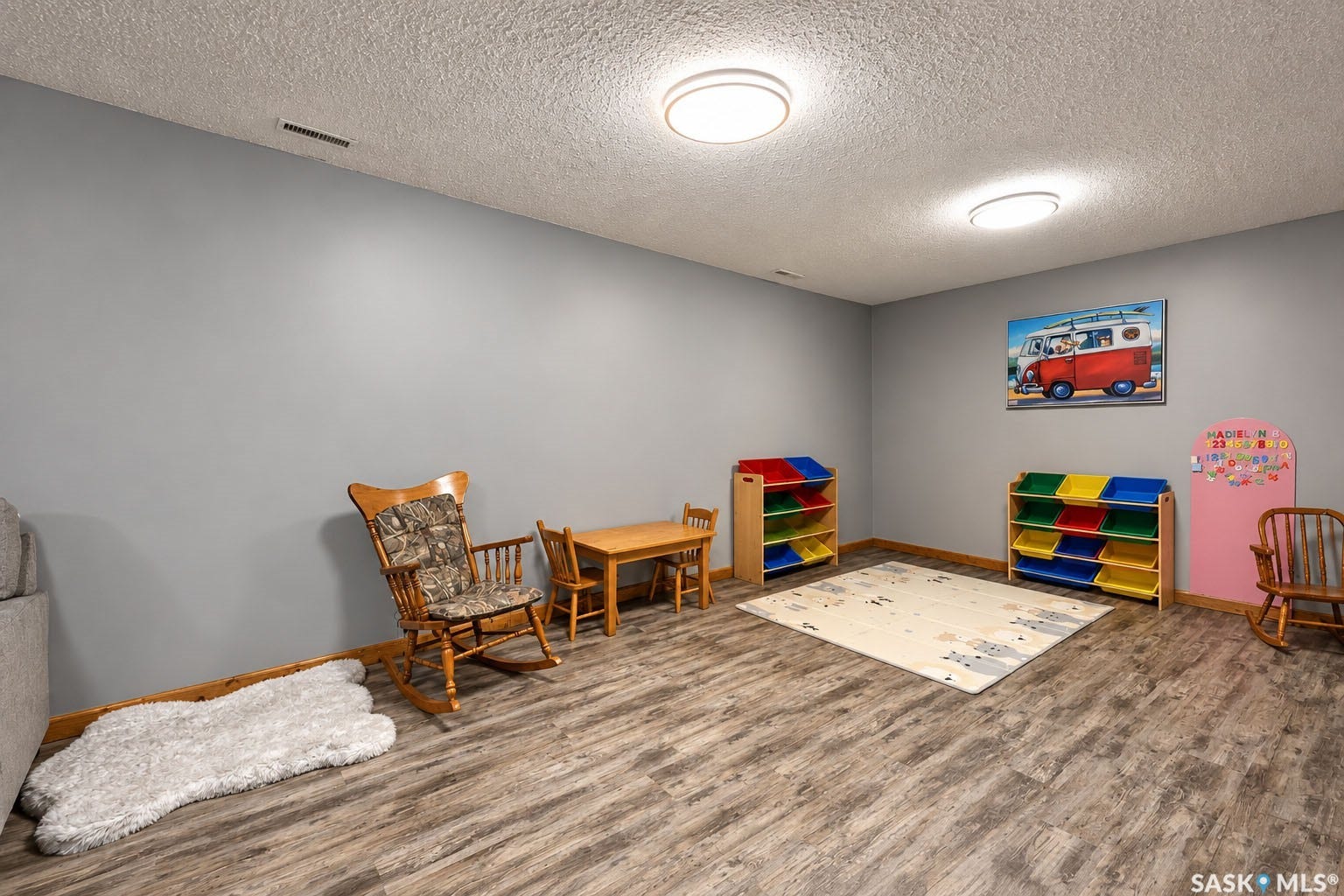 Recessed lighting fixtures, wood-finish flooring, and light gray walls