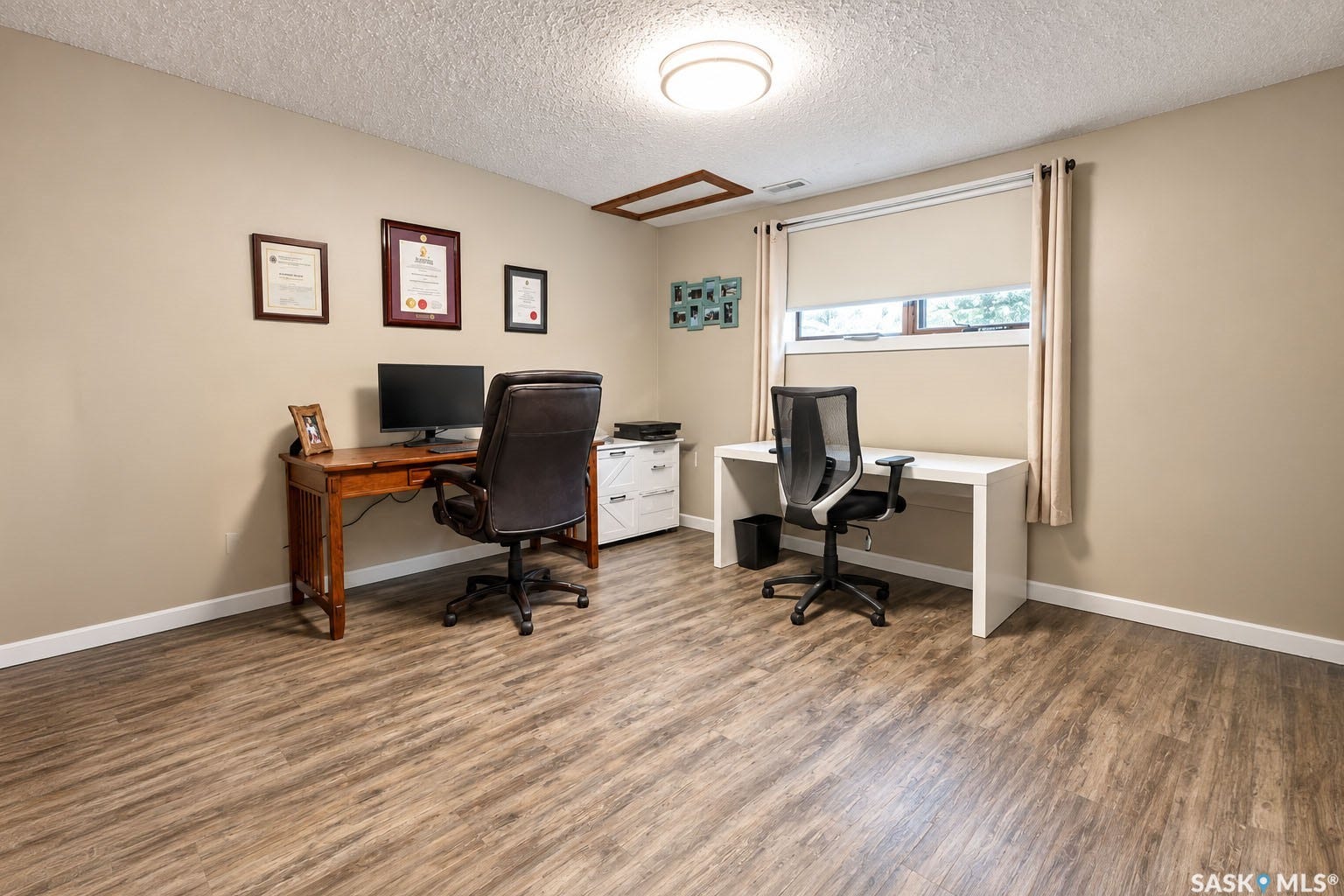Wood-finish flooring, neutral wall tones, and a flush-mount ceiling light