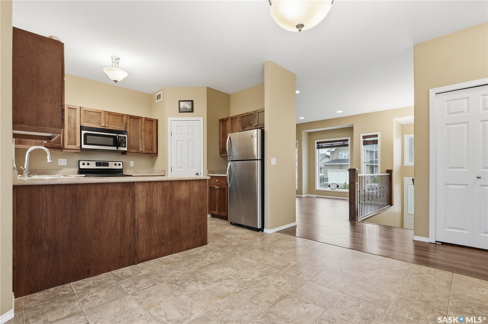 Kitchen featuring wood cabinetry, stainless steel appliances, and a built-in microwave